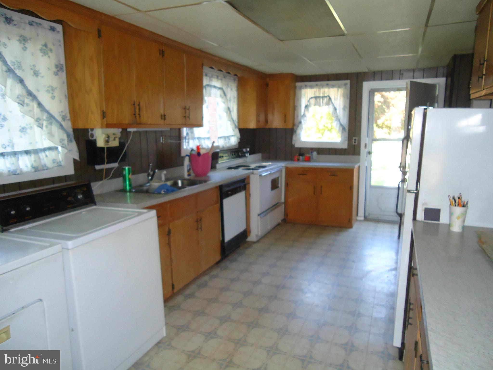 20175 Windy Lane Coltons Point, MD 20626 - Photo 9 of 14 a kitchen with a sink stove and cabinets