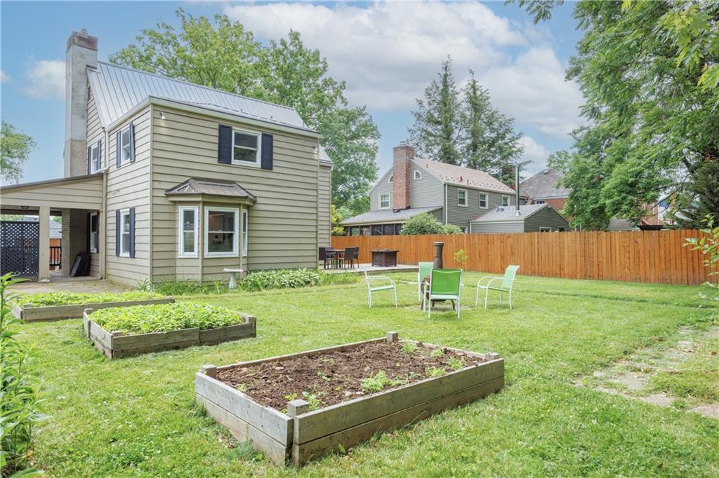 1025 Old Gate Road Pittsburgh, PA 15235 - Photo 22 of 27 a backyard of a house with wooden fence and a large tree