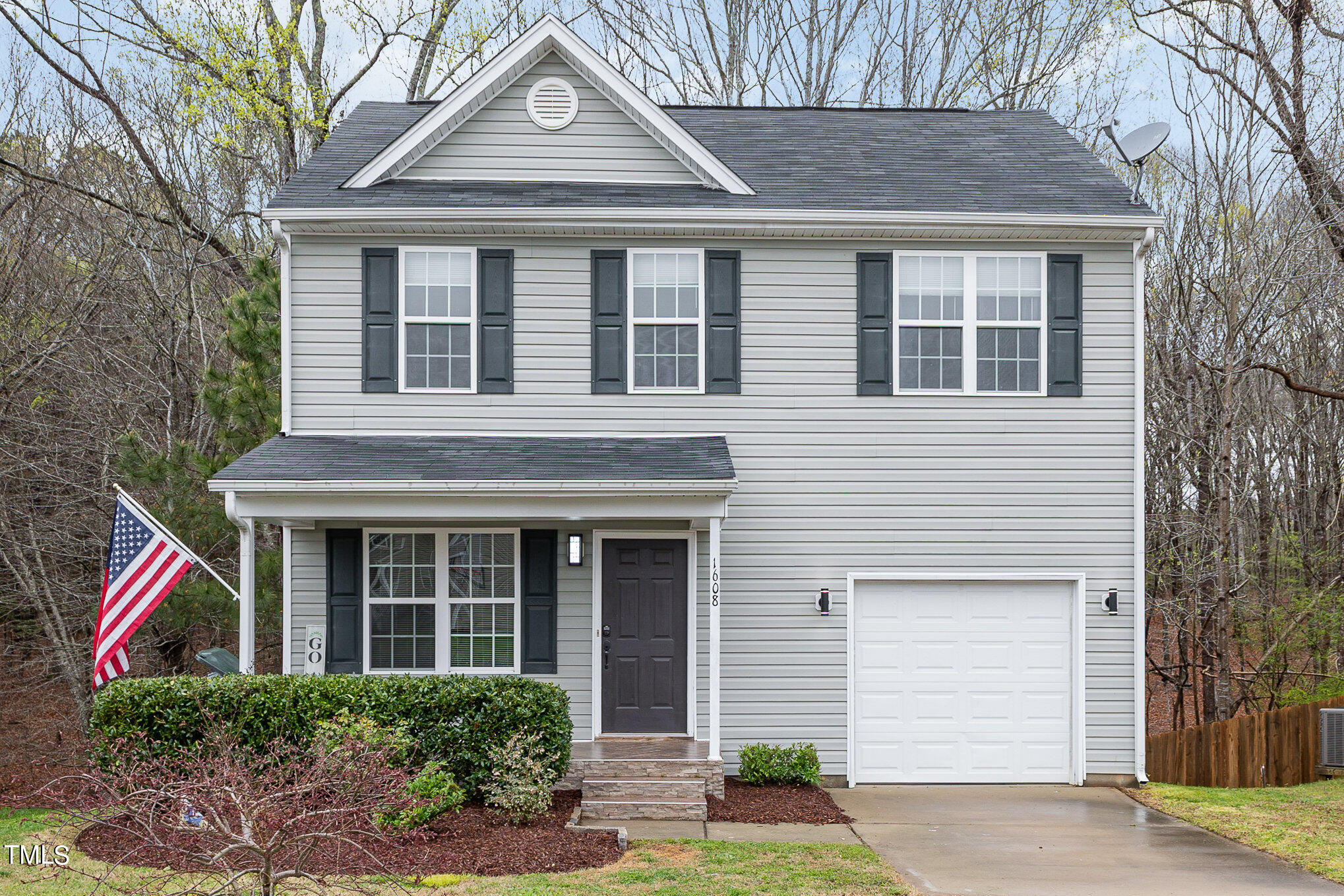 1608 Moineau Lane Raleigh, NC 27610 - Photo 1 of 15 a front view of a house with a yard and potted plants