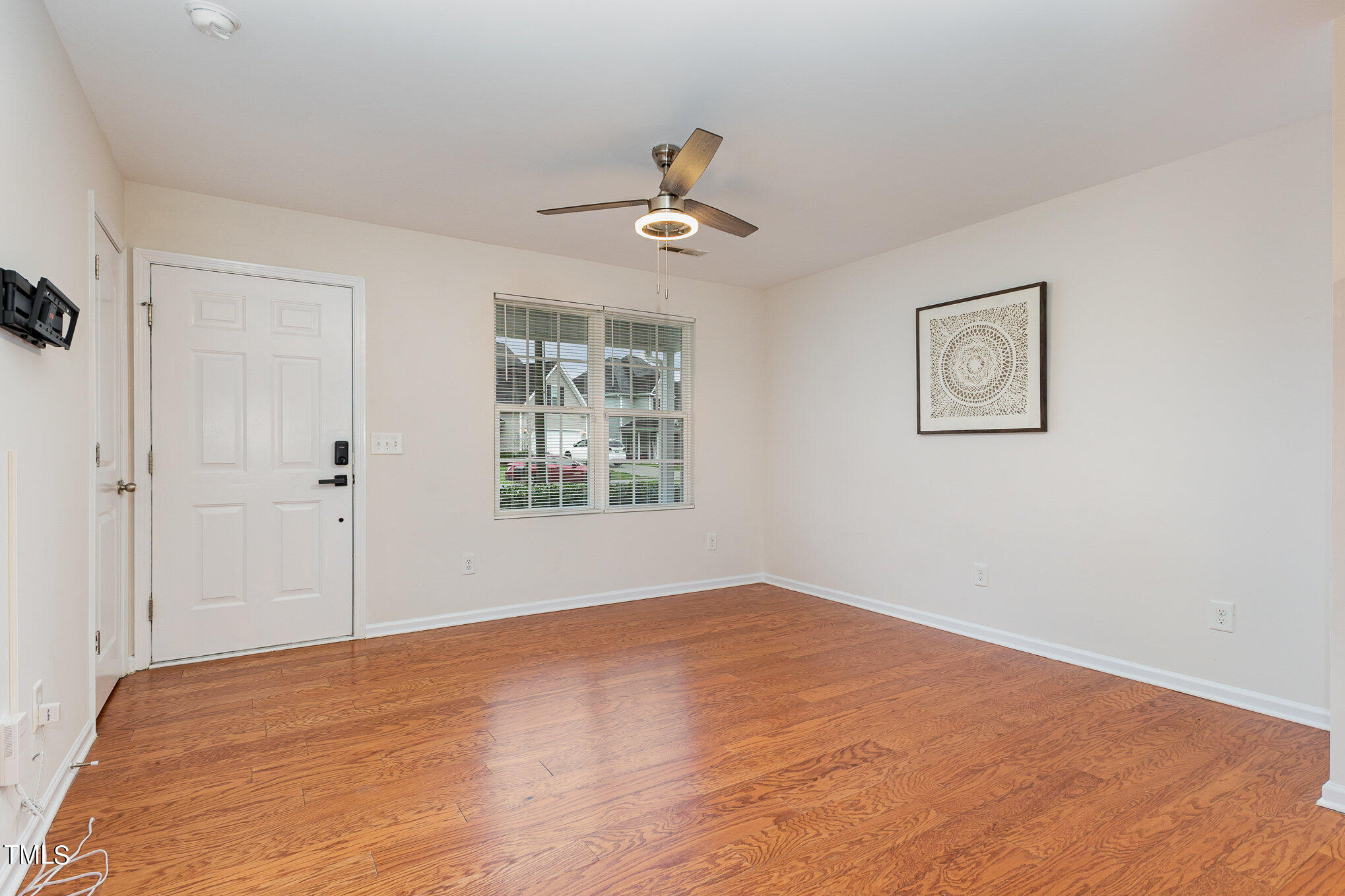 1608 Moineau Lane Raleigh, NC 27610 - Photo 5 of 15 an empty room with fan and windows
