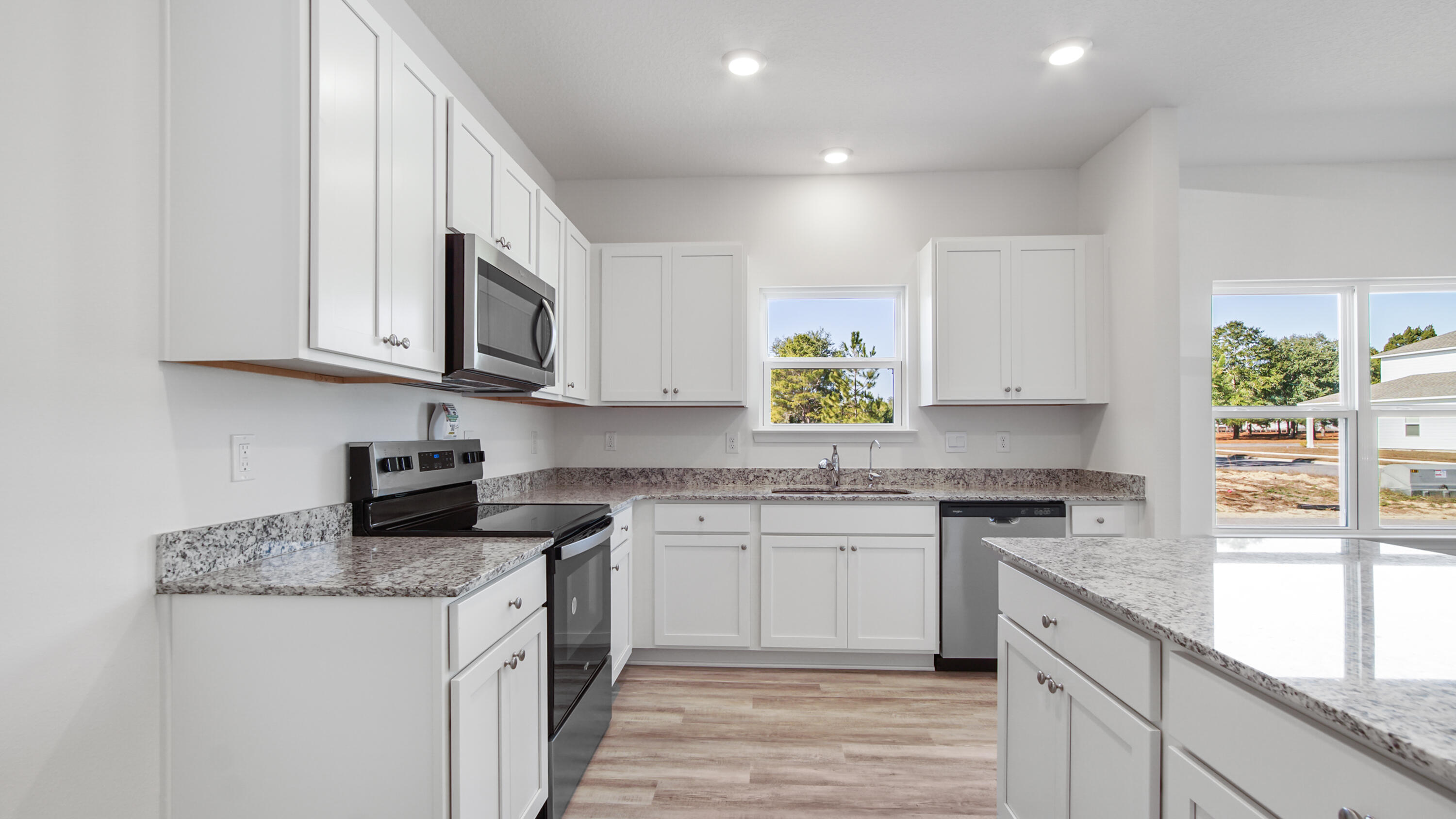 186 Huckleberry Street Freeport, FL 32439 - Photo 2 of 33 a kitchen with stainless steel appliances granite countertop a stove a sink and a granite counter tops