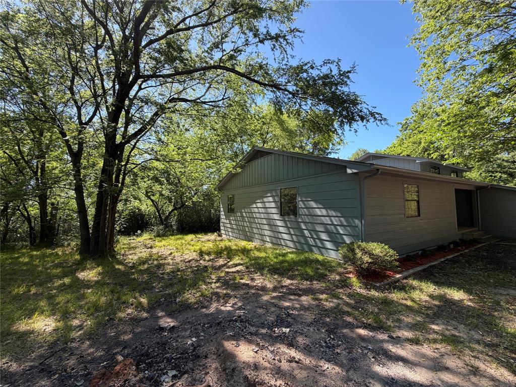 257 West Acres Road Gun Barrel City, TX 75156 - Photo 3 of 22 a house is sitting in middle of forest