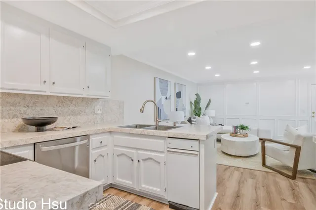 a kitchen with a sink appliances and cabinets