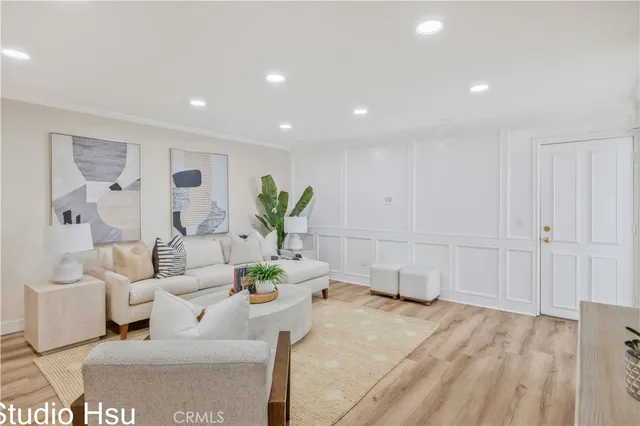 a living room with furniture and flowers