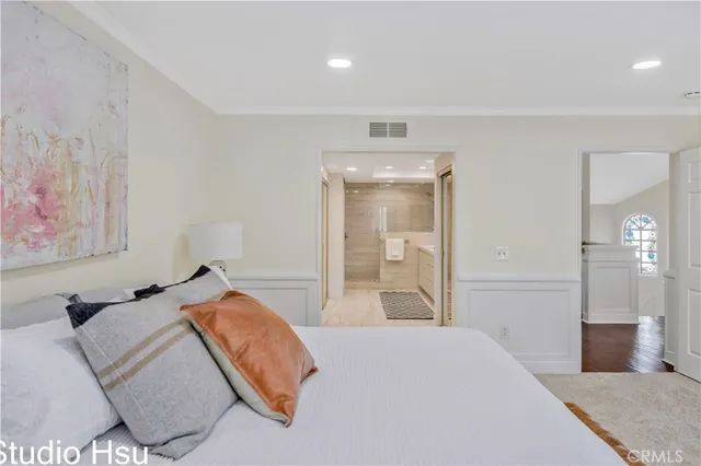 a bedroom with a bed and a painting on the wall