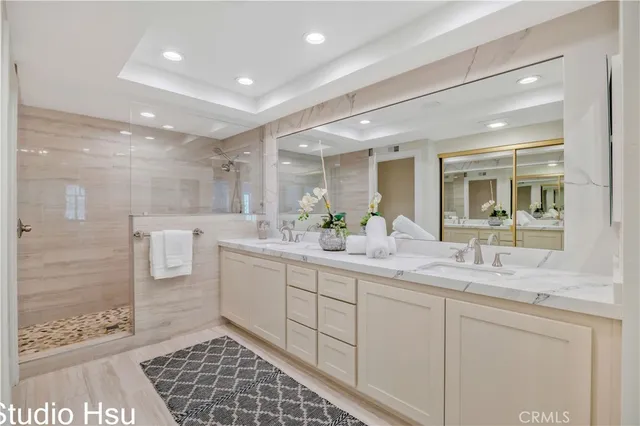 a bathroom with a double vanity sink and a mirror