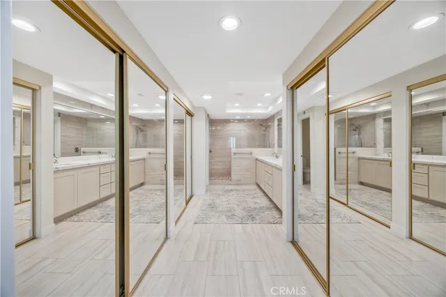 a bathroom with a glass shower door and a glass door