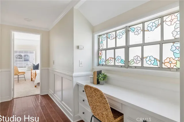 a dining room with furniture and a large window