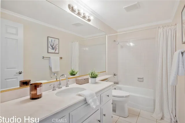 a bathroom with a granite countertop sink a toilet and shower