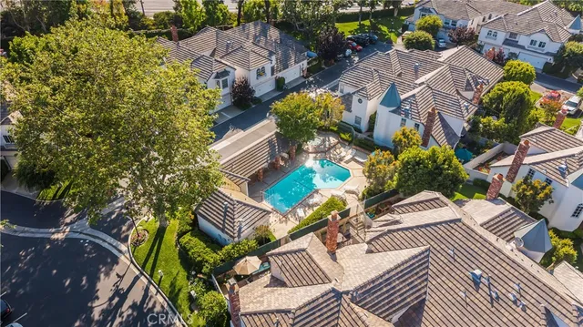an aerial view of residential house with swimming pool and lawn chairs