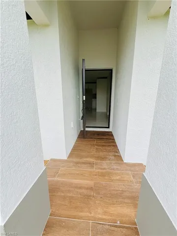 a view of hallway with wooden floor