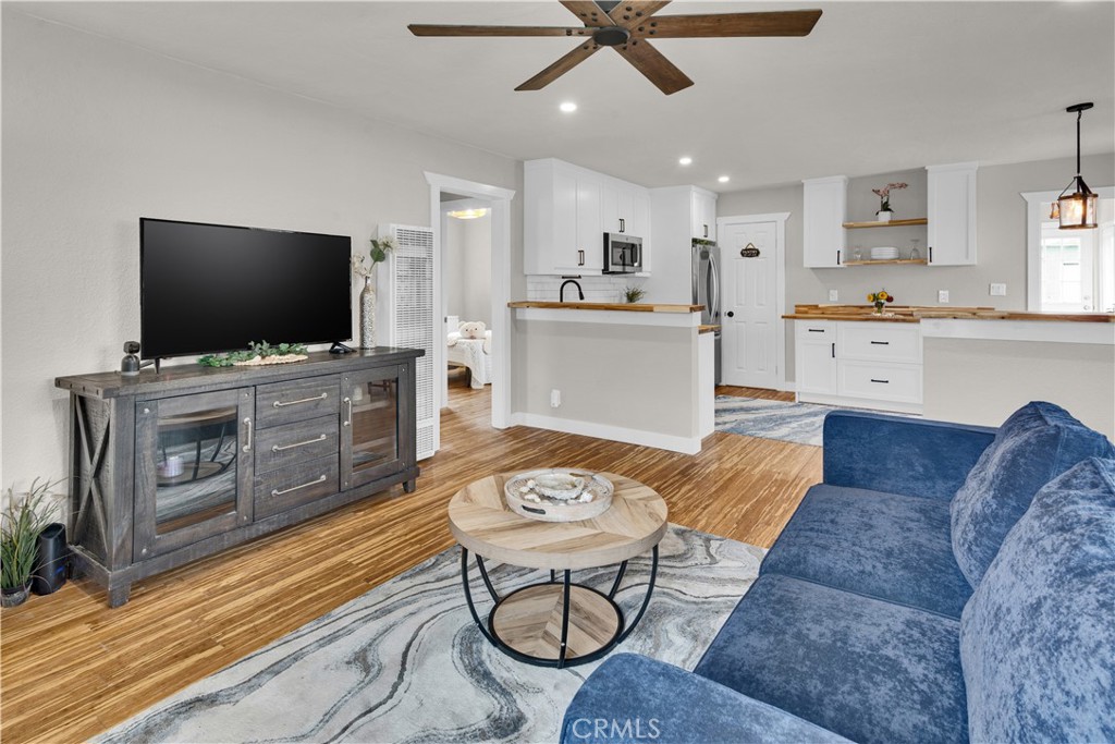 848 Mentone Avenue Grover Beach, CA 93433 - Photo 13 of 33 a living room with furniture a flat screen tv and kitchen view