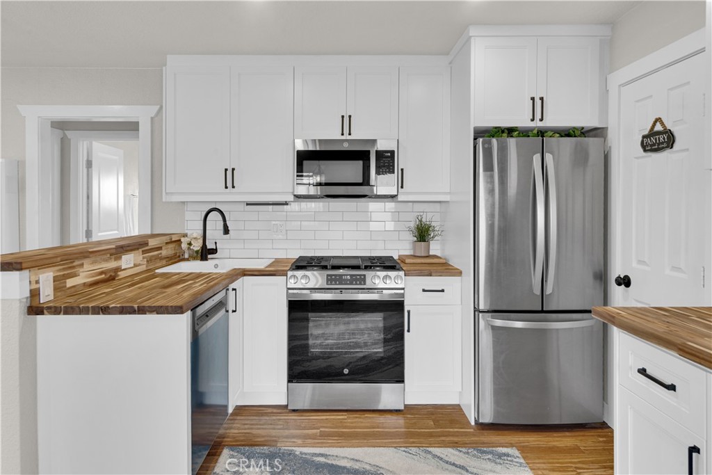 848 Mentone Avenue Grover Beach, CA 93433 - Photo 17 of 33 a kitchen with stainless steel appliances granite countertop a refrigerator stove and sink
