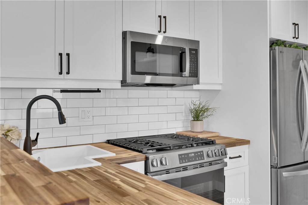 848 Mentone Avenue Grover Beach, CA 93433 - Photo 18 of 33 a kitchen with granite countertop a stove and a microwave