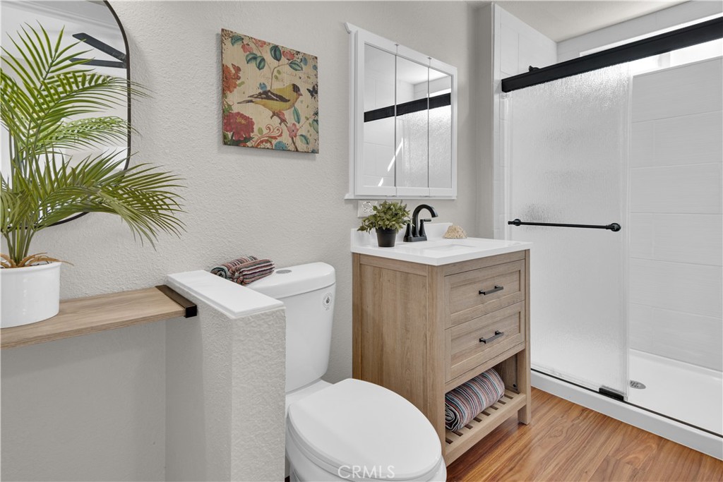 848 Mentone Avenue Grover Beach, CA 93433 - Photo 22 of 33 a bathroom with a sink mirror vanity and toilet