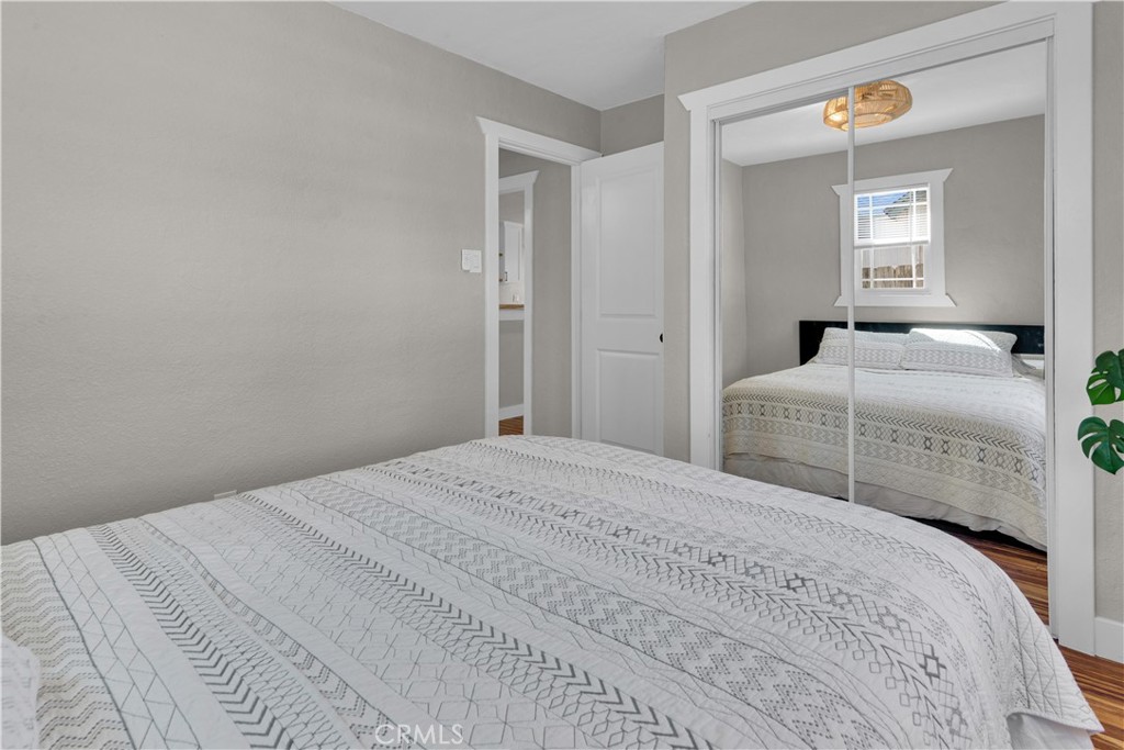 848 Mentone Avenue Grover Beach, CA 93433 - Photo 25 of 33 a bedroom with a bed and closet with mirror