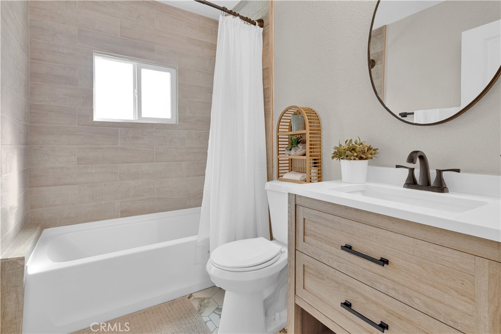 848 Mentone Avenue Grover Beach, CA 93433 - Photo 28 of 33 a bathroom with a sink a toilet and a mirror
