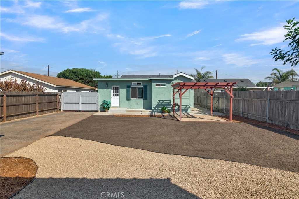 848 Mentone Avenue Grover Beach, CA 93433 - Photo 5 of 33 a view of a house with a backyard and a garage