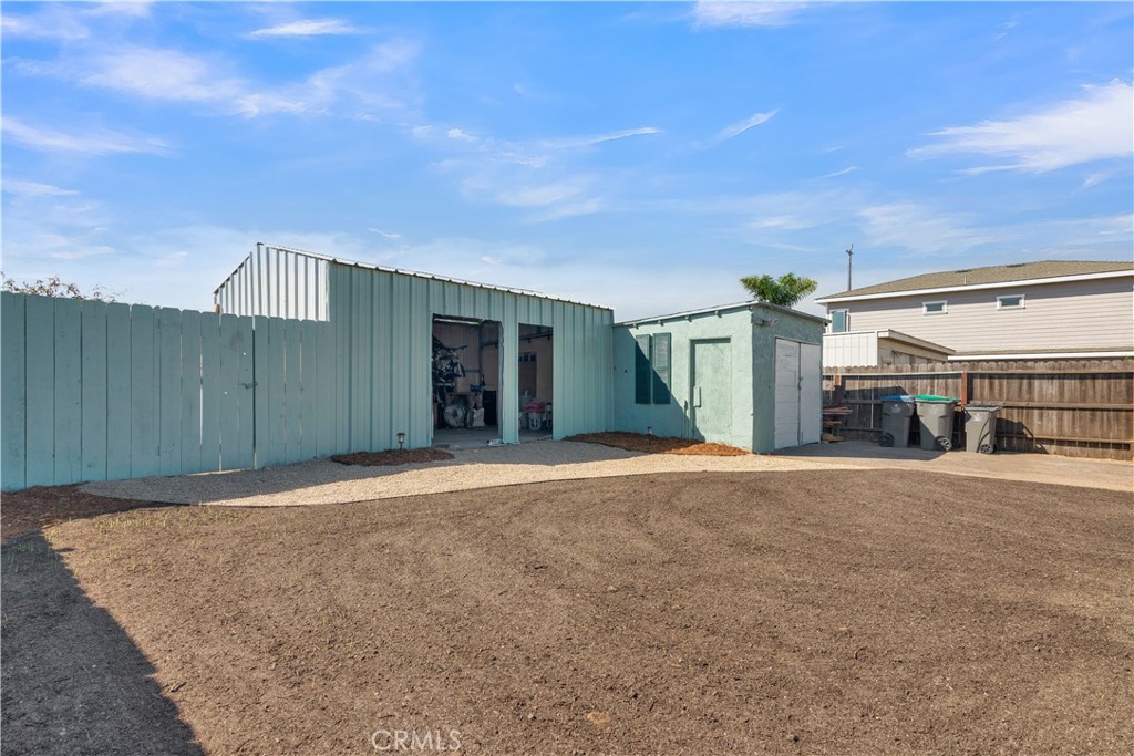 848 Mentone Avenue Grover Beach, CA 93433 - Photo 9 of 33 a front view of a house with a yard and garage