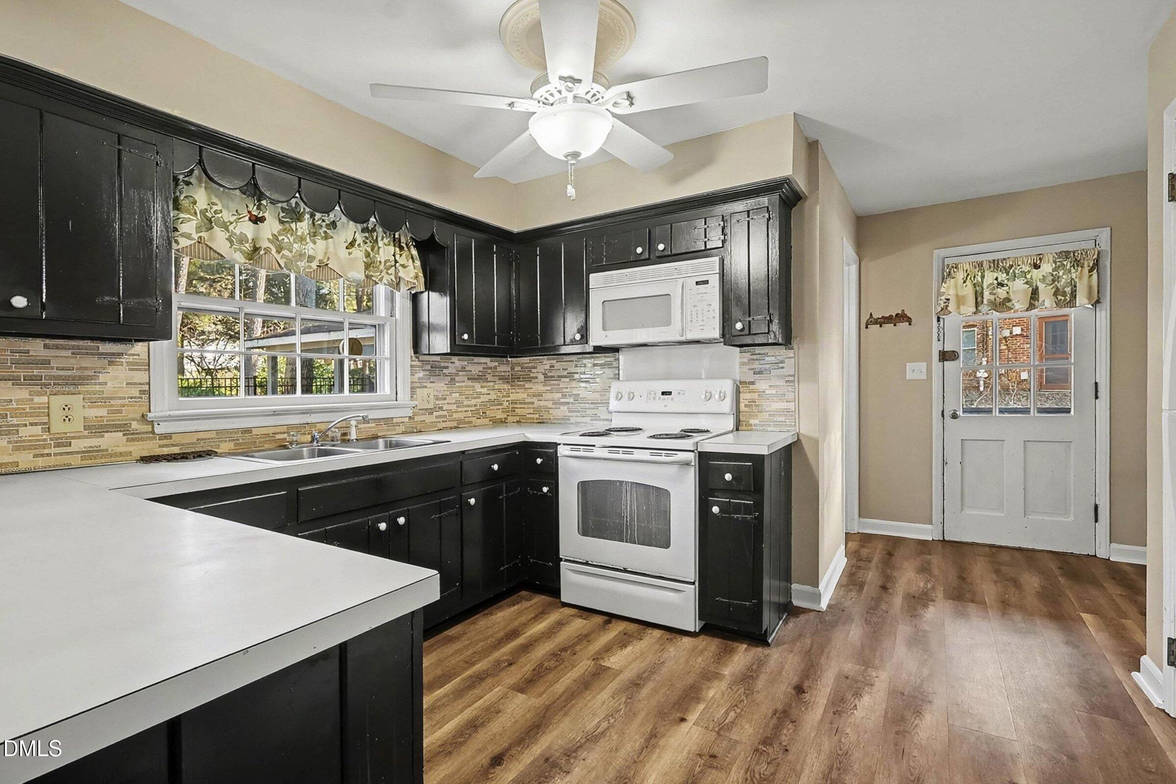3704 Pembrook Place Raleigh, NC 27612 - Photo 15 of 68 a kitchen with stainless steel appliances granite countertop a stove a sink and a refrigerator