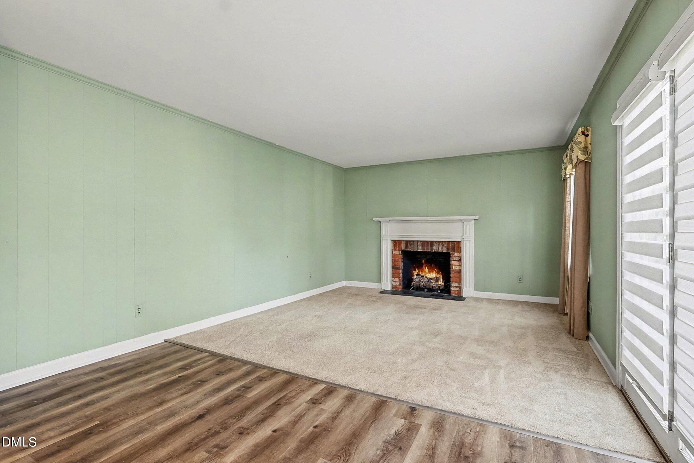 3704 Pembrook Place Raleigh, NC 27612 - Photo 22 of 68 a view of an empty room with a window and a fireplace