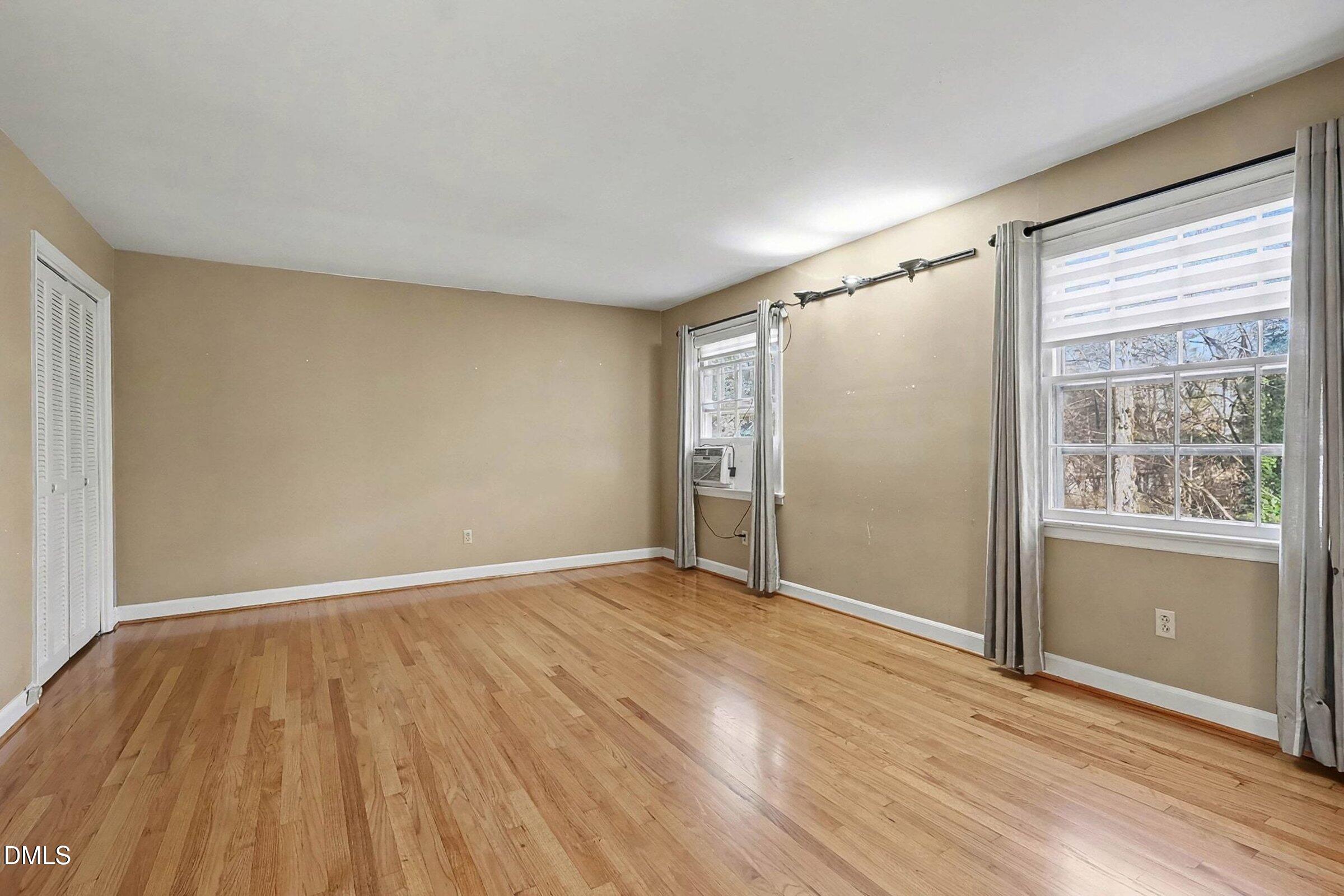 3704 Pembrook Place Raleigh, NC 27612 - Photo 26 of 68 an empty room with wooden floor and windows