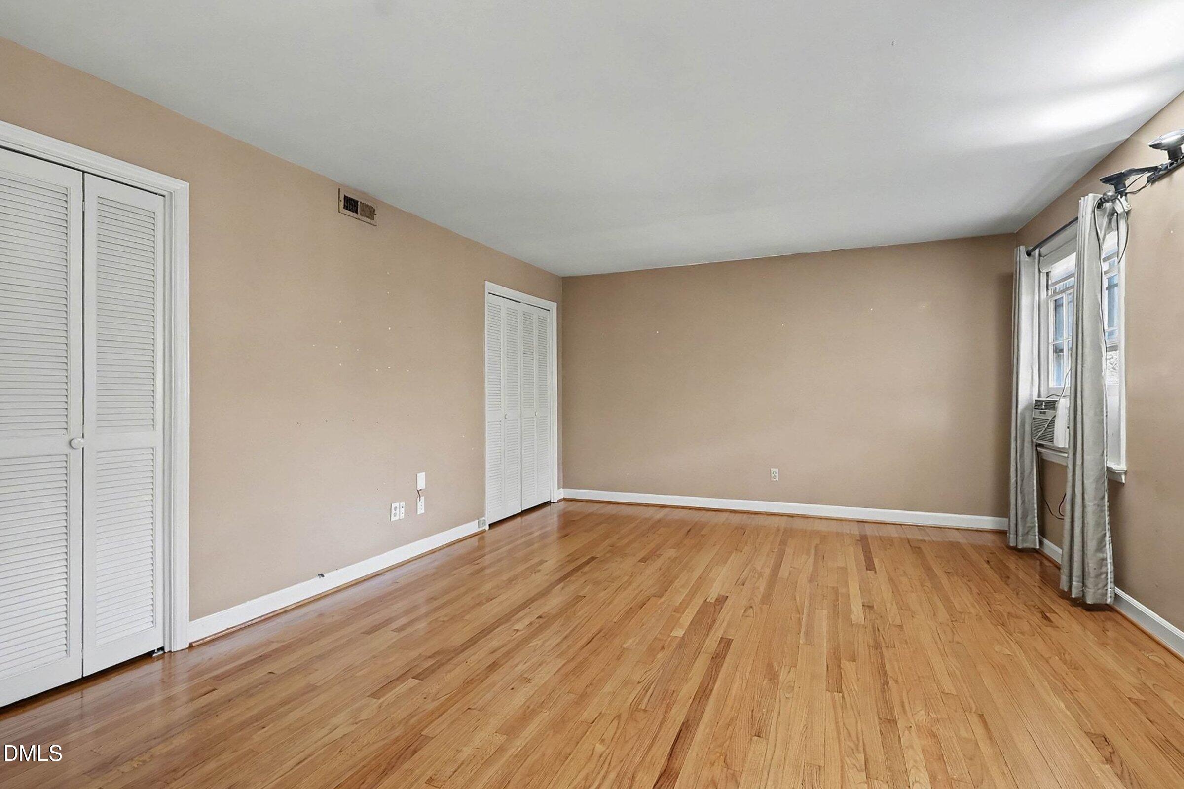 3704 Pembrook Place Raleigh, NC 27612 - Photo 30 of 68 a view of an empty room with wooden floor and a window