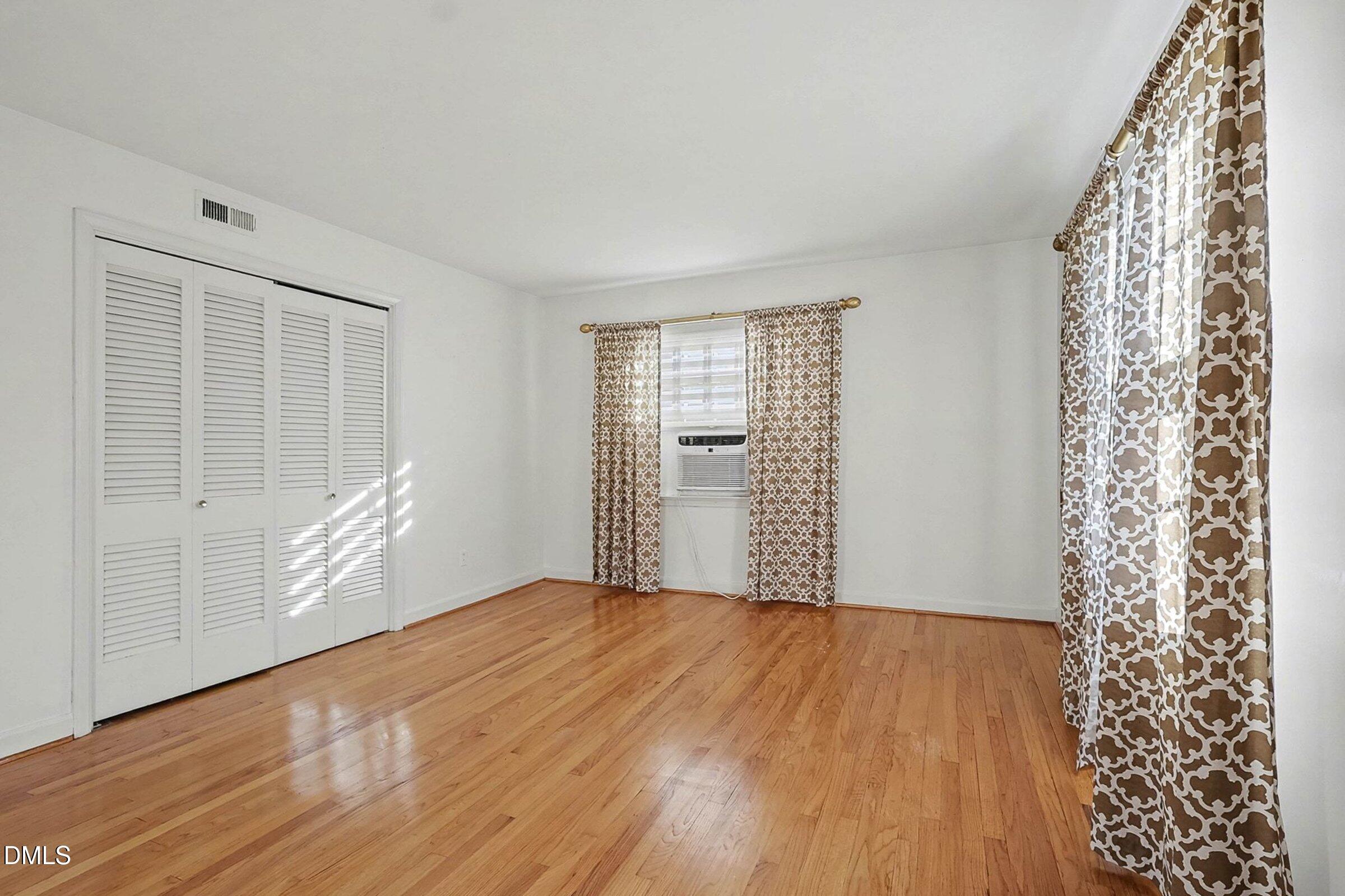 3704 Pembrook Place Raleigh, NC 27612 - Photo 33 of 68 a view of an empty room with a window and wooden floor