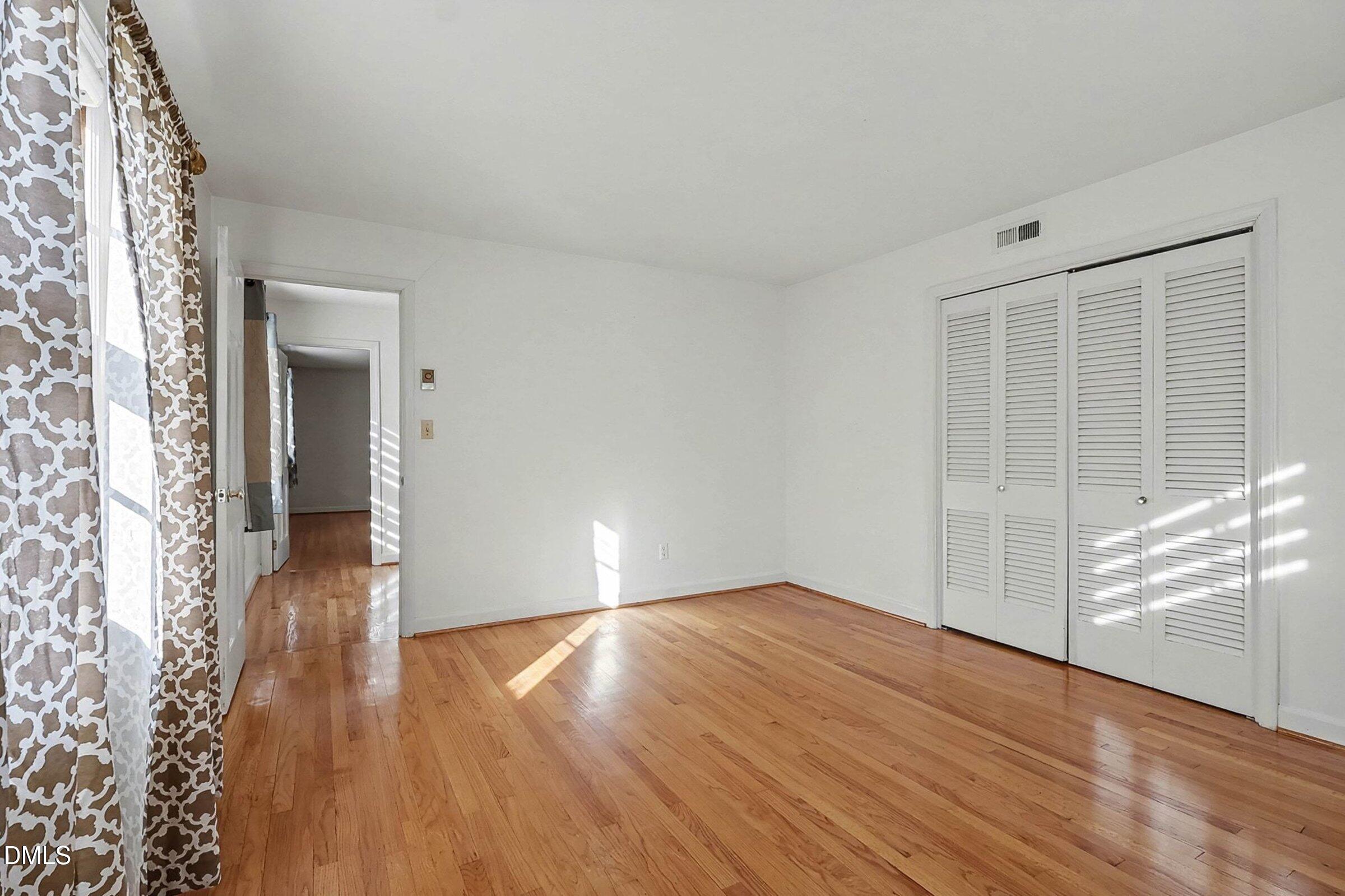 3704 Pembrook Place Raleigh, NC 27612 - Photo 34 of 68 wooden floor in an empty room with a window