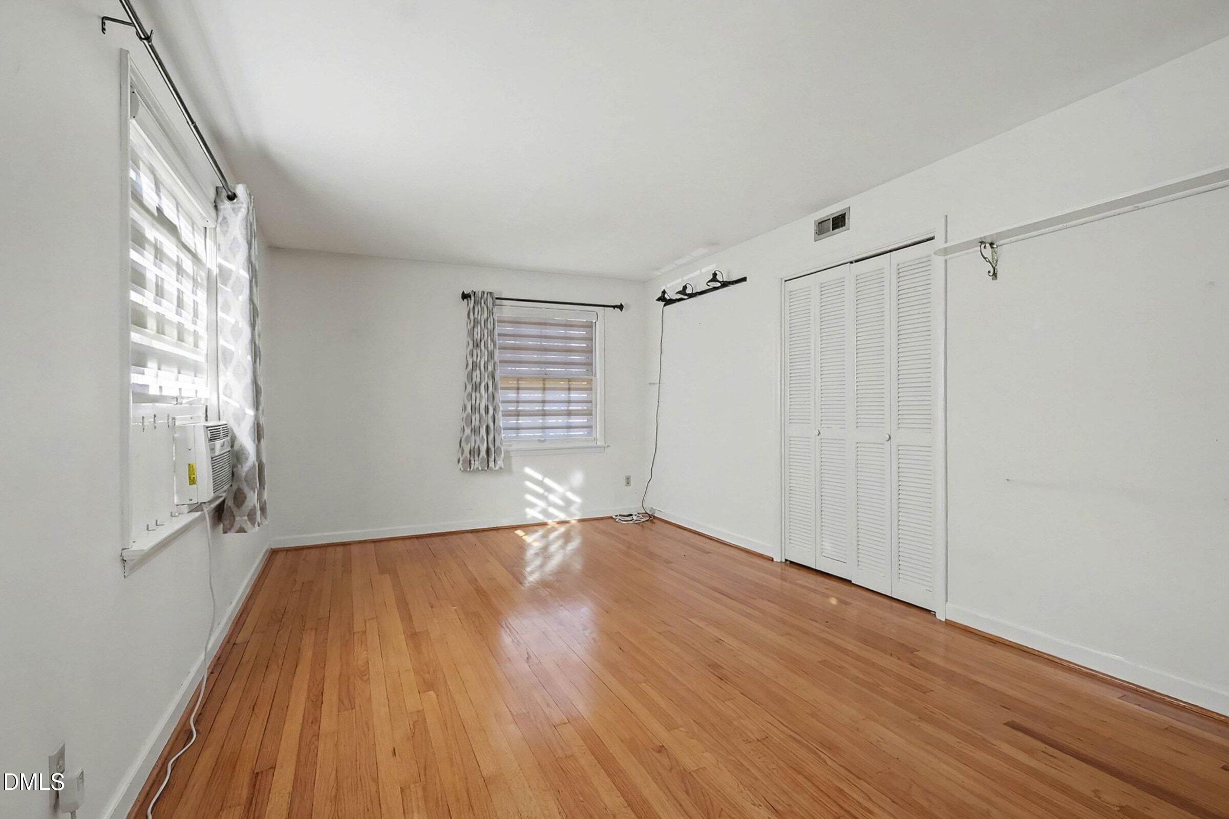 3704 Pembrook Place Raleigh, NC 27612 - Photo 35 of 68 a view of an empty room with wooden floor and a window