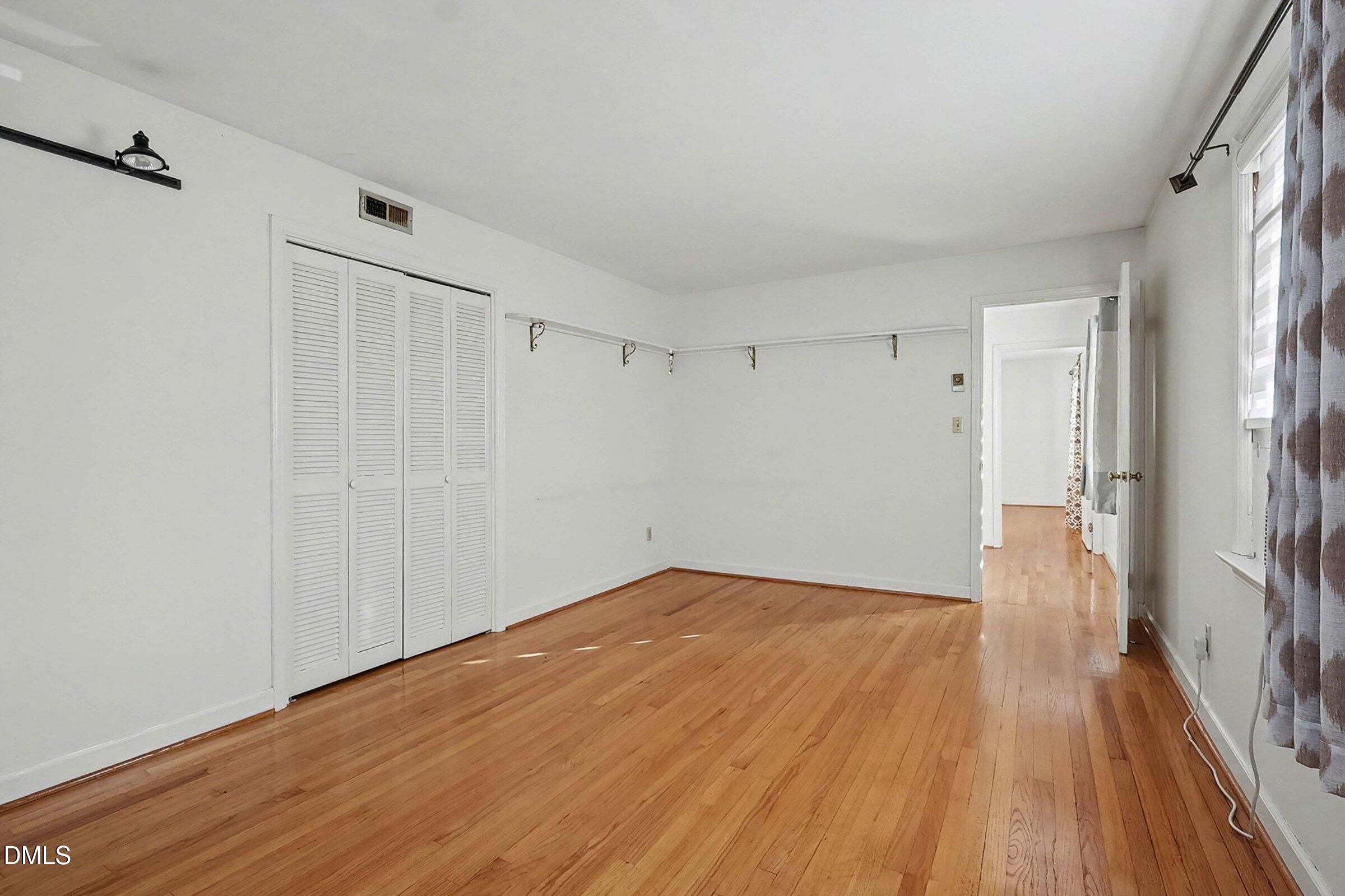 3704 Pembrook Place Raleigh, NC 27612 - Photo 36 of 68 a view of a big room with wooden floor and a window
