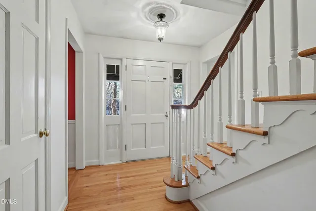 a view of entryway and hall with wooden floor