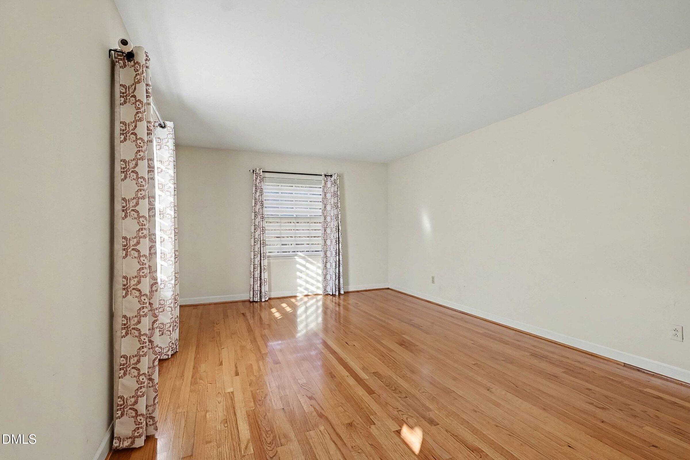3704 Pembrook Place Raleigh, NC 27612 - Photo 8 of 68 a view of empty room with wooden floor and fan