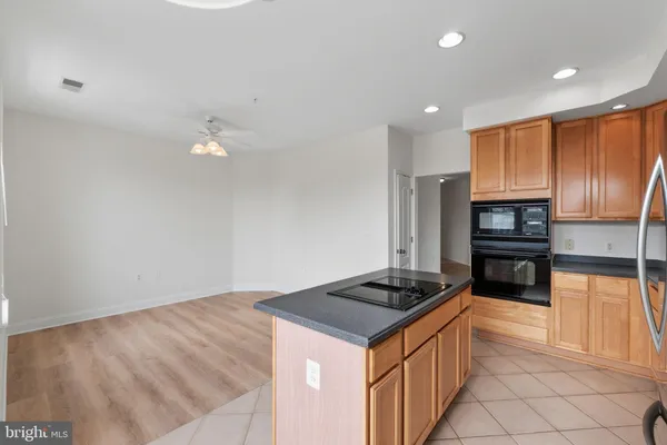 a kitchen with granite countertop stainless steel appliances and wooden cabinets