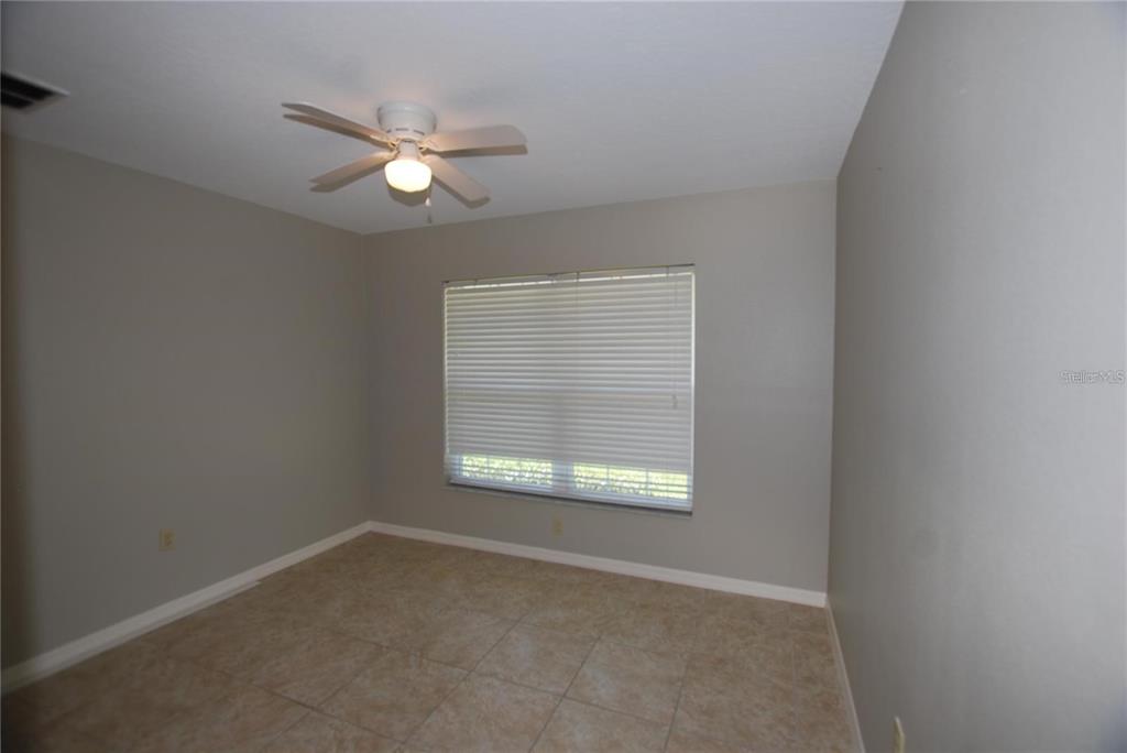 312 East Hibiscus Drive Lakeland, FL 33803 - Photo 13 of 25 an empty room with a window and a fan