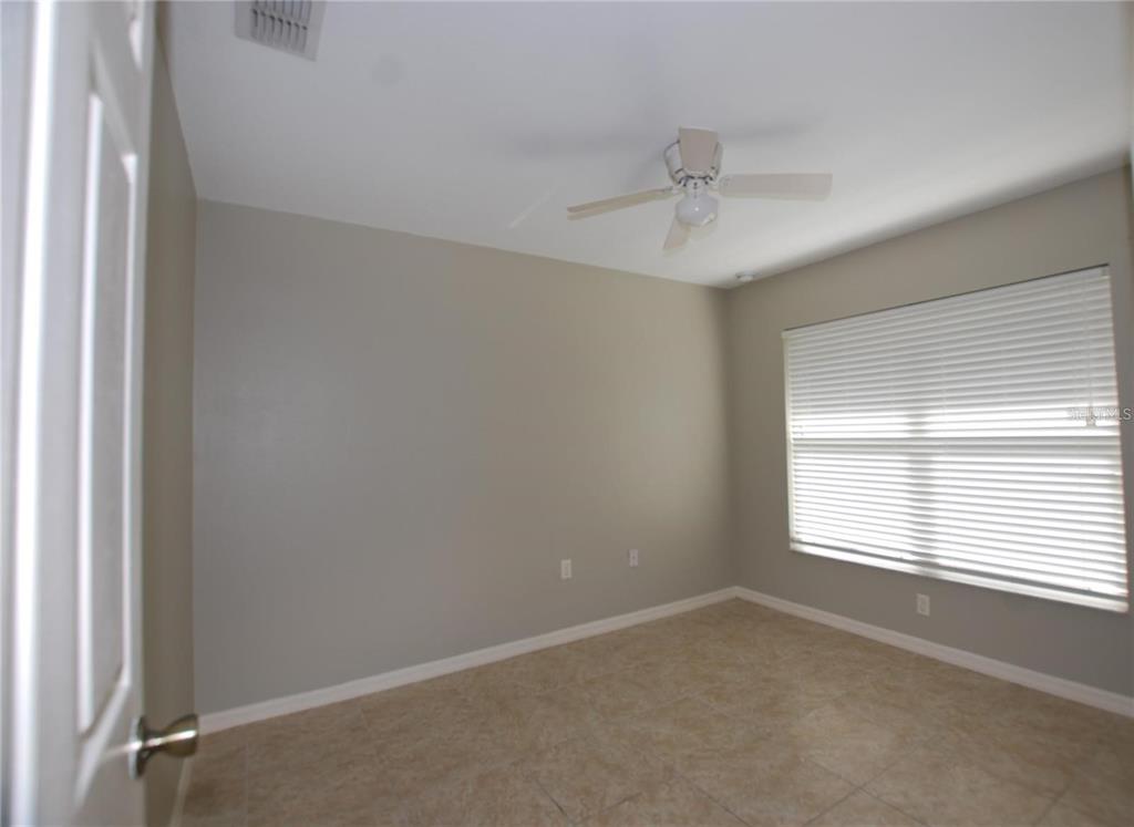 312 East Hibiscus Drive Lakeland, FL 33803 - Photo 15 of 25 an empty room with windows and ceiling fan