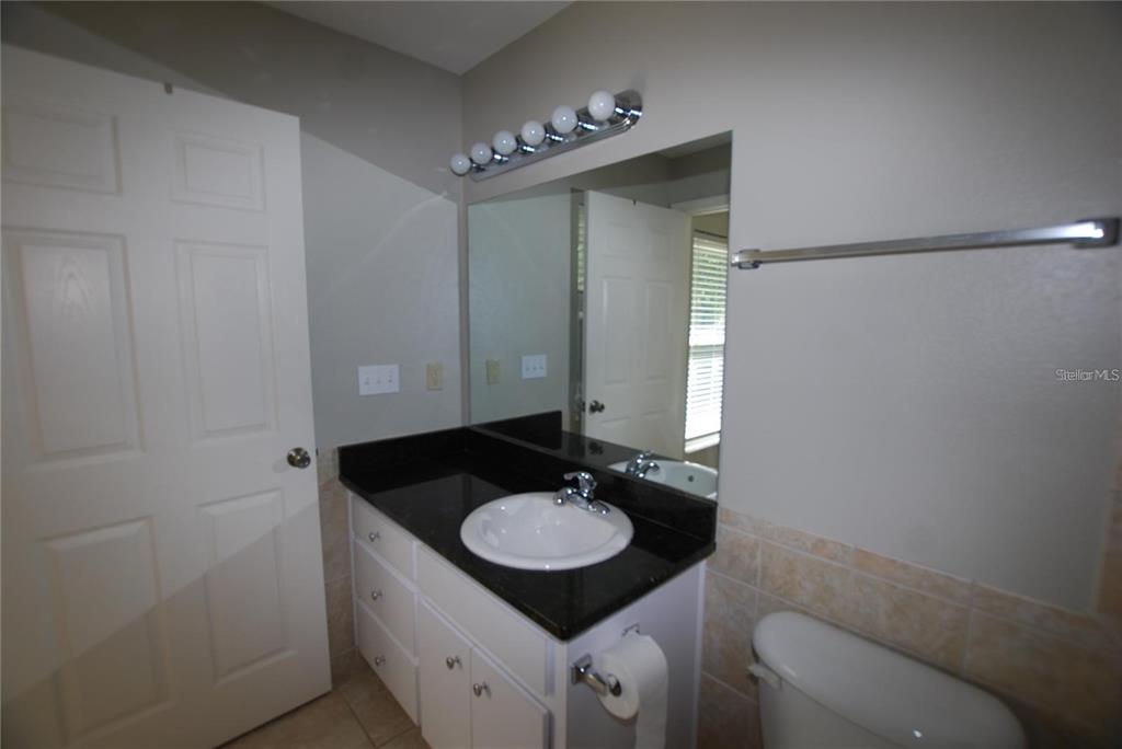312 East Hibiscus Drive Lakeland, FL 33803 - Photo 19 of 25 a bathroom with a sink and a mirror