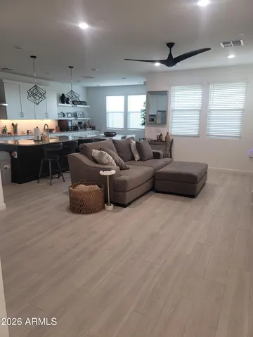 a living room with furniture a fireplace and a chandelier
