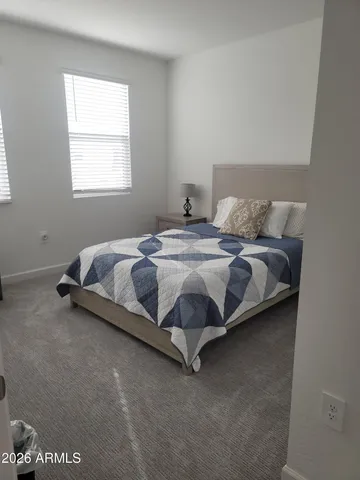 a spacious bathroom with a double vanity sink a mirror and a shower