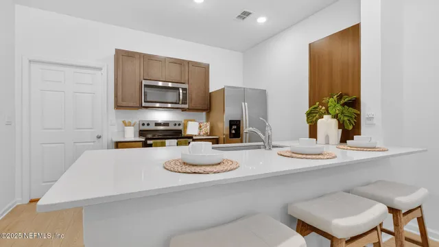 a kitchen with a table and chairs