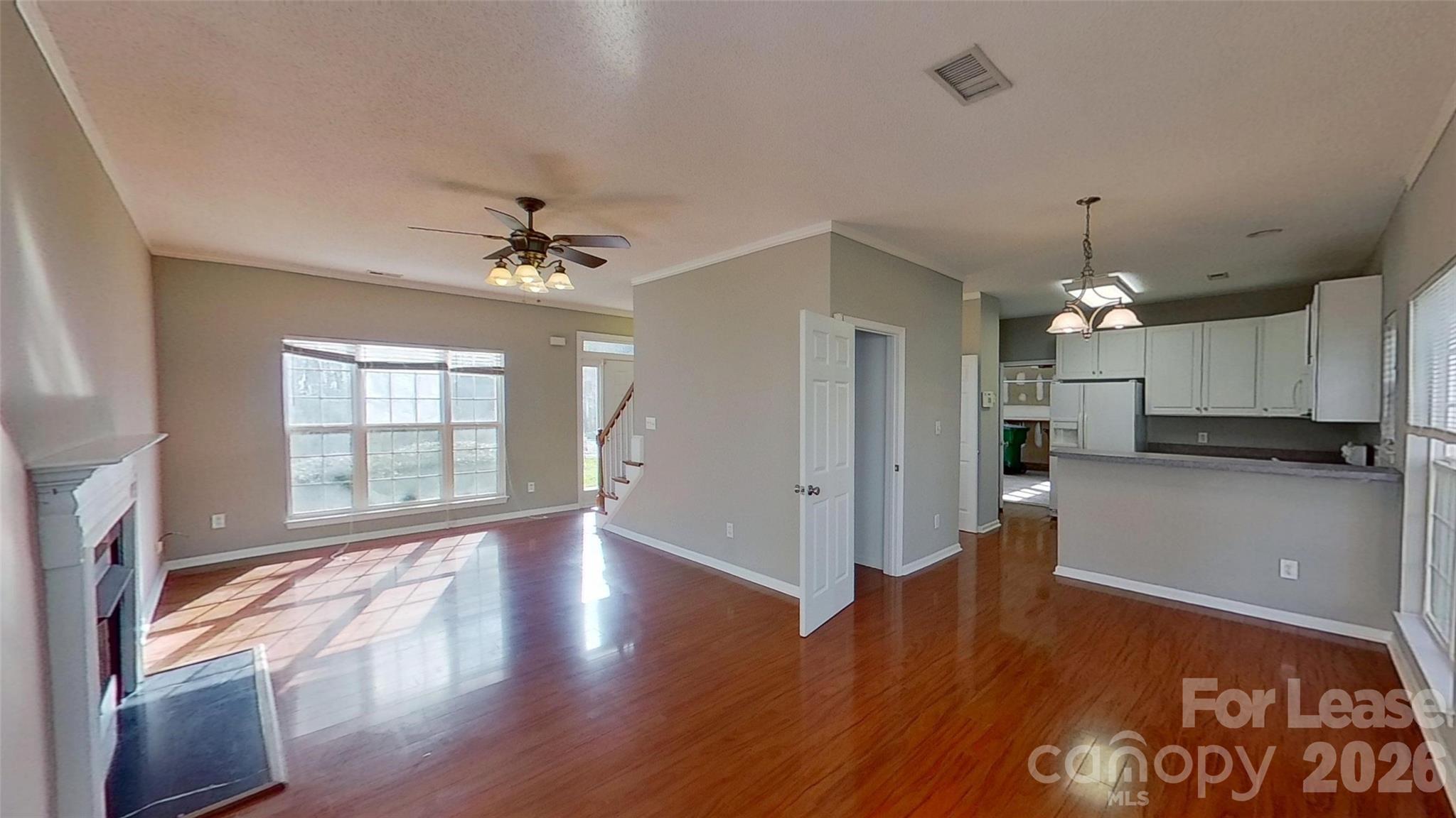 7236 Rock Island Road Charlotte, NC 28278 - Photo 2 of 11 a view of a livingroom with a ceiling fan window hardwood floor and a ceiling fan