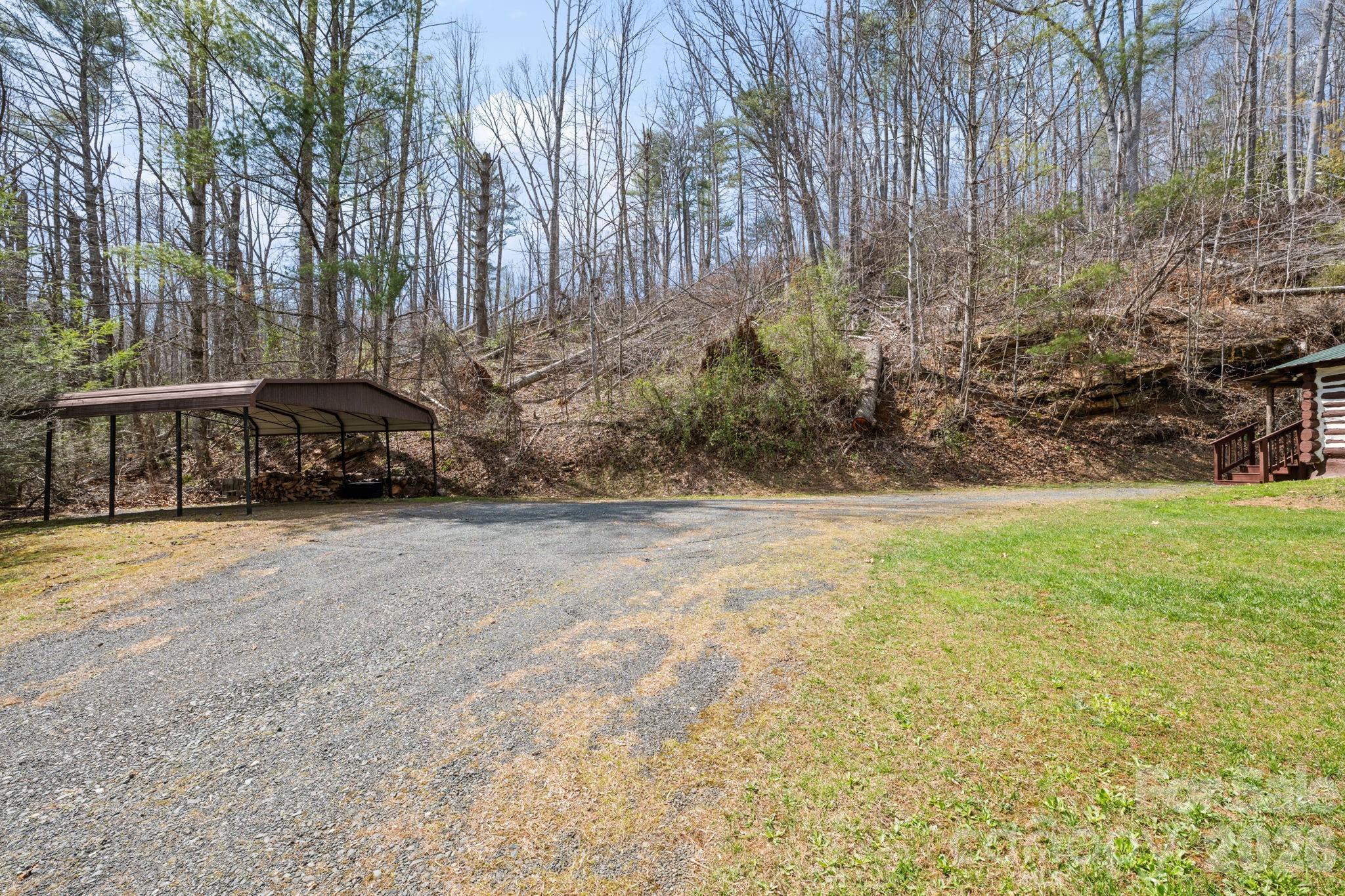 245 Davenport Road Spruce Pine, NC 28777 - Photo 20 of 25 a car parked in front of a road with large trees
