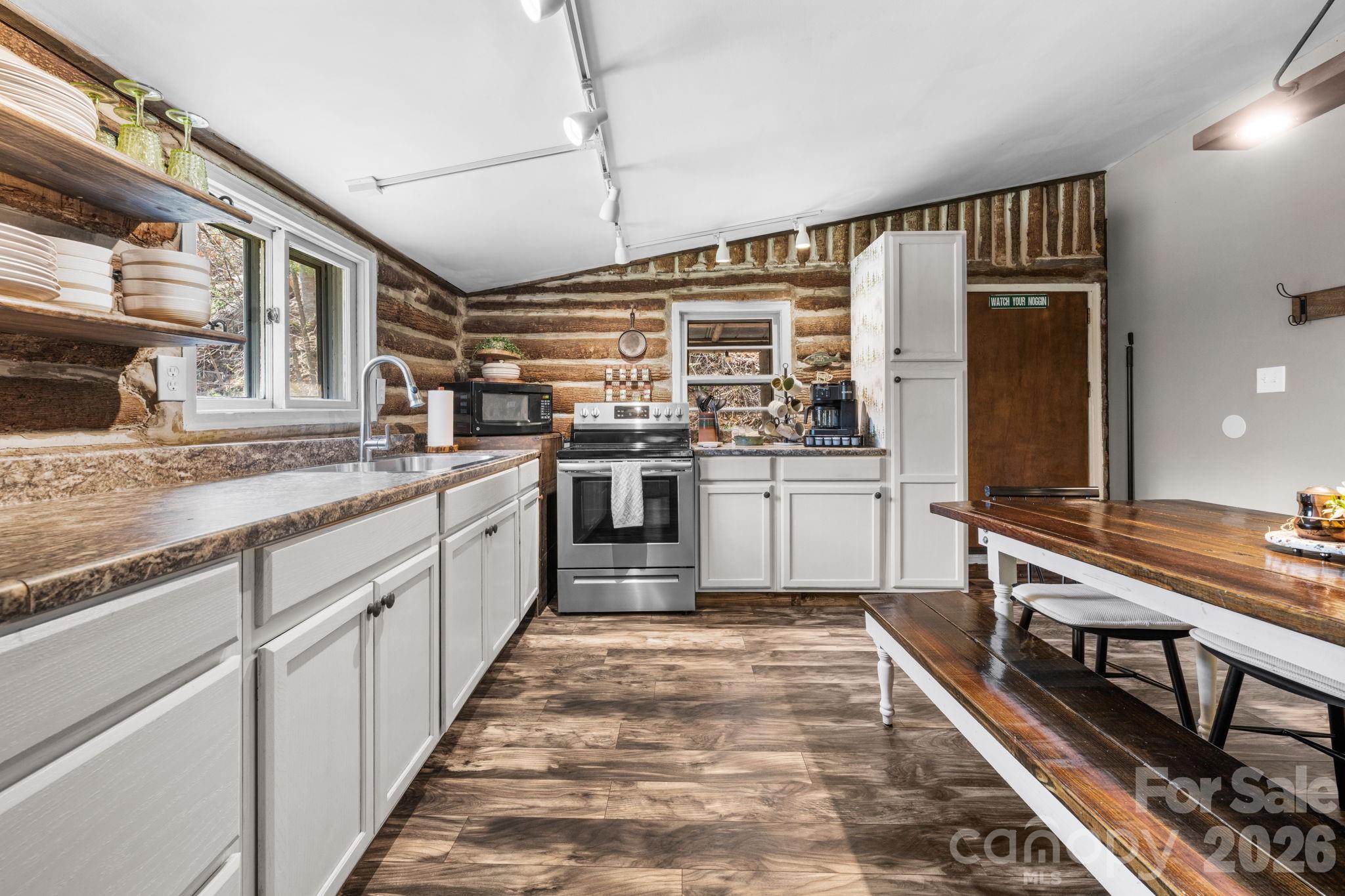245 Davenport Road Spruce Pine, NC 28777 - Photo 7 of 25 a large kitchen with stainless steel appliances granite countertop a stove and a sink