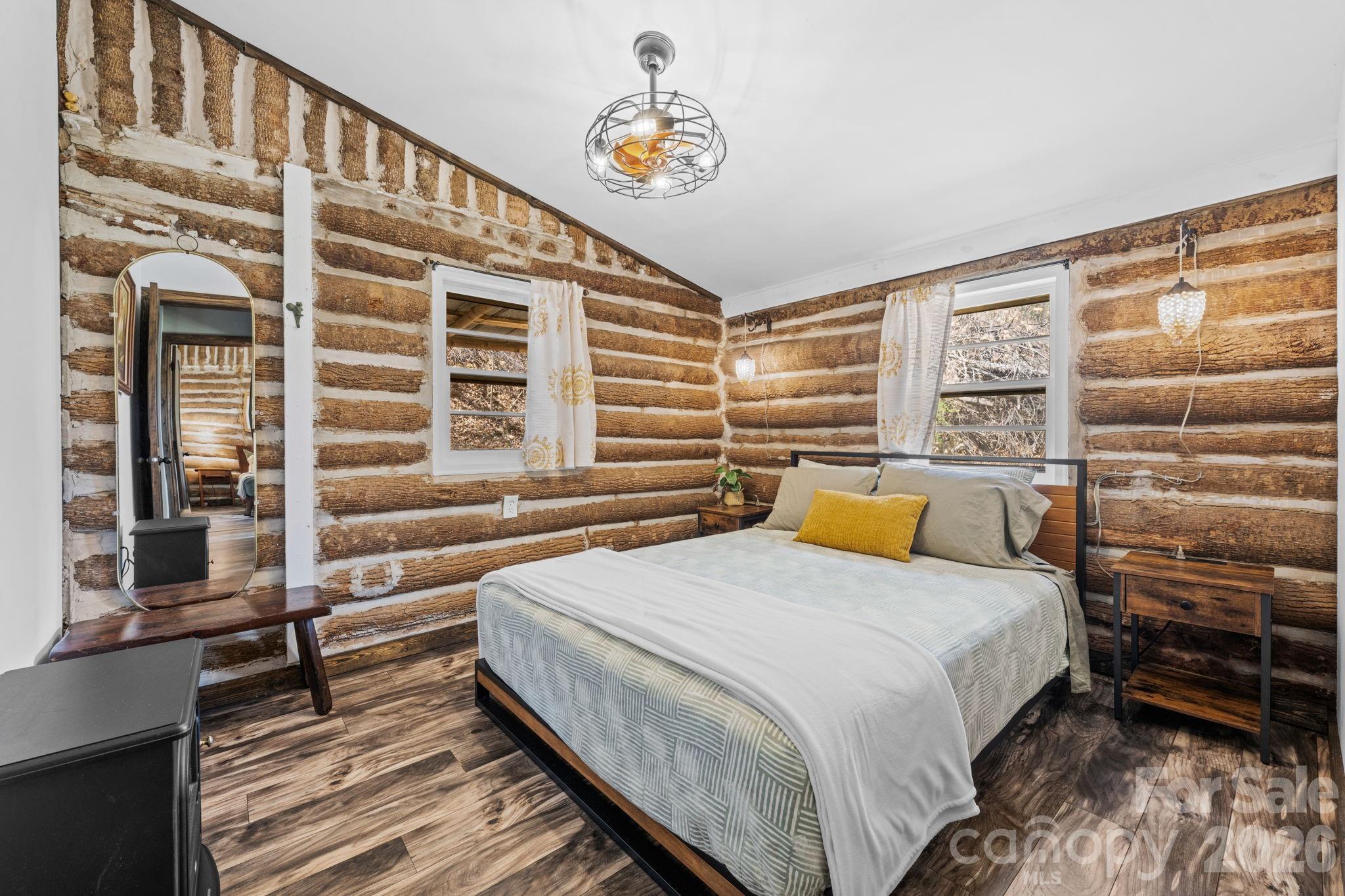 245 Davenport Road Spruce Pine, NC 28777 - Photo 10 of 25 a bedroom with a bed and wooden floor