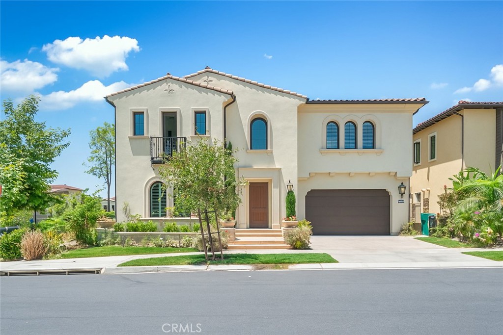 52 Eider Run Irvine, CA 92618 - Photo 1 of 46 a front view of a house with a yard and garage