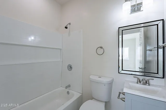 a bathroom with a toilet a sink and a mirror