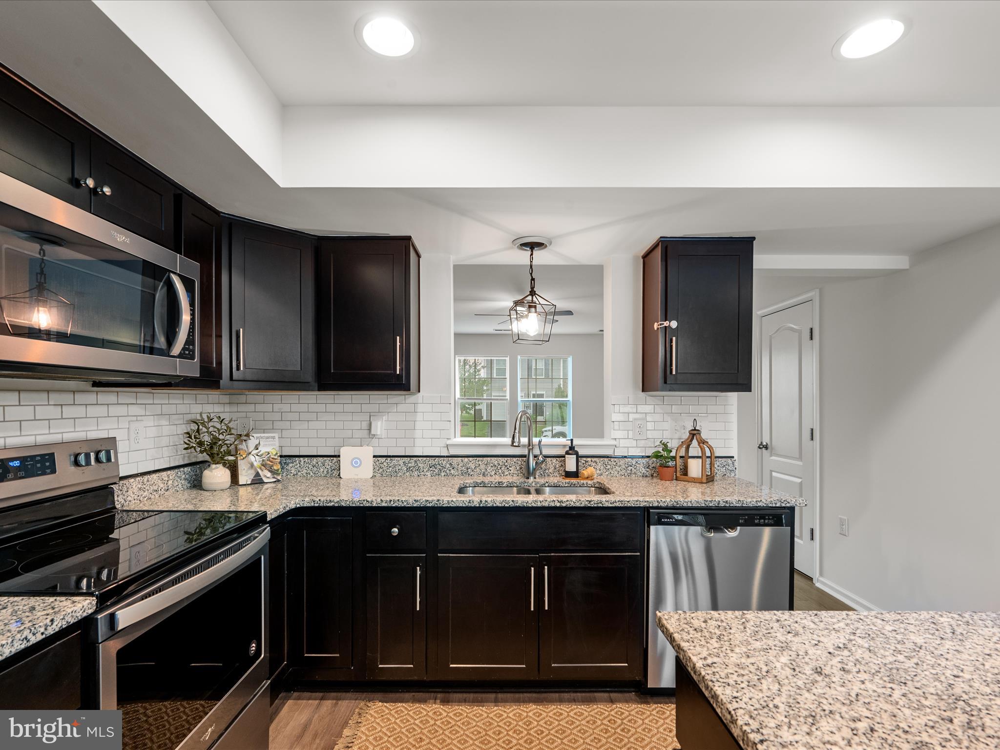 576 Thumper Drive Ranson, WV 25438 - Photo 12 of 37 a kitchen with a sink stove and microwave