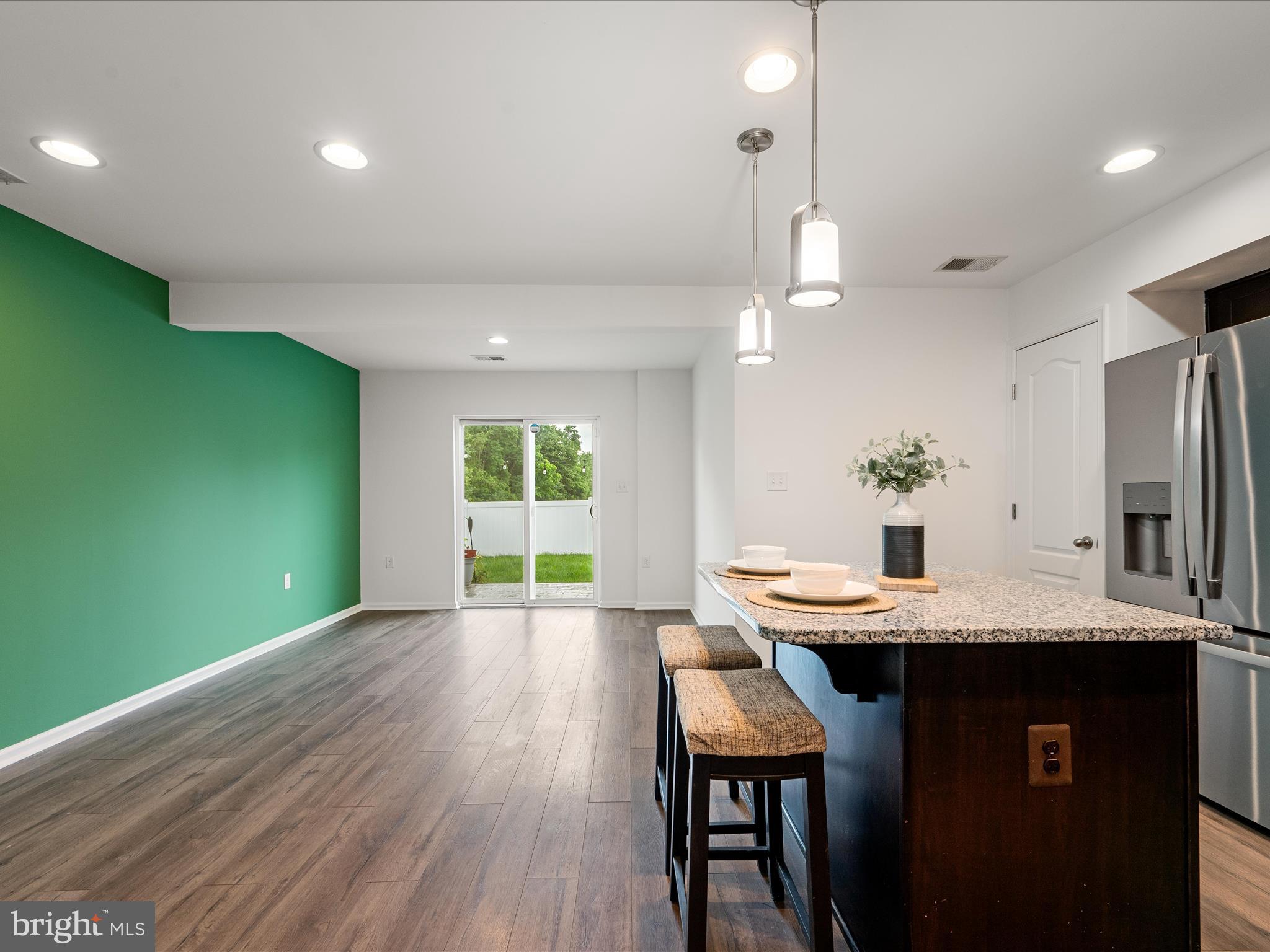 576 Thumper Drive Ranson, WV 25438 - Photo 14 of 37 a kitchen with kitchen island a sink table and chairs
