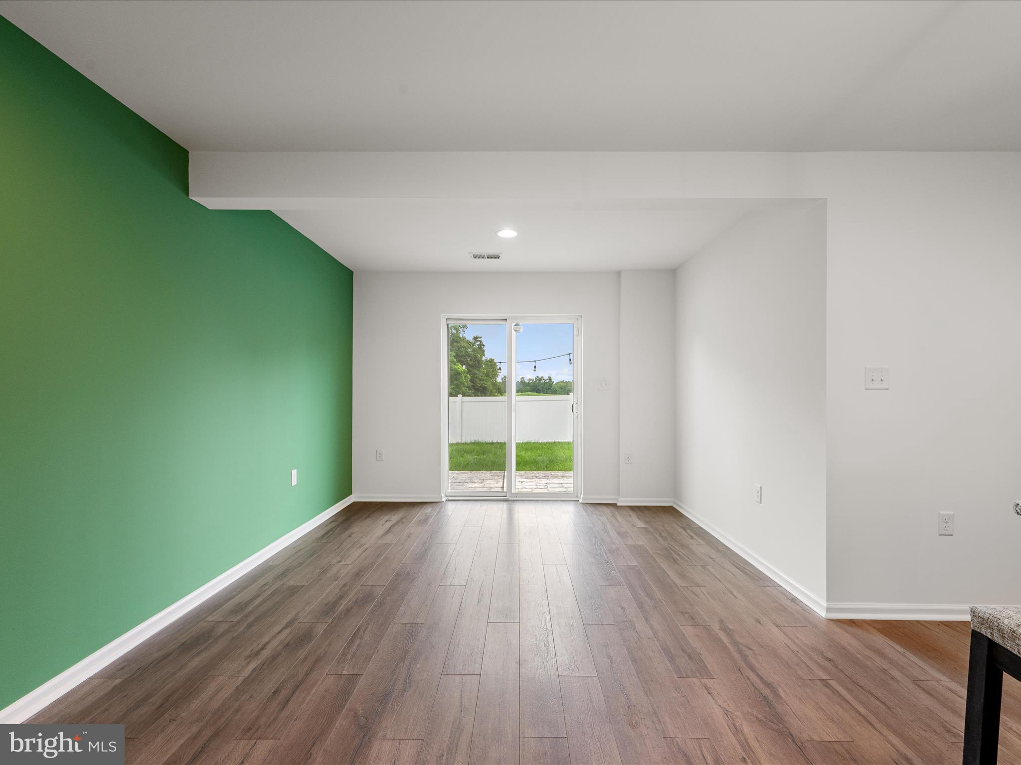 576 Thumper Drive Ranson, WV 25438 - Photo 17 of 37 a view of an empty room with wooden floor and a window