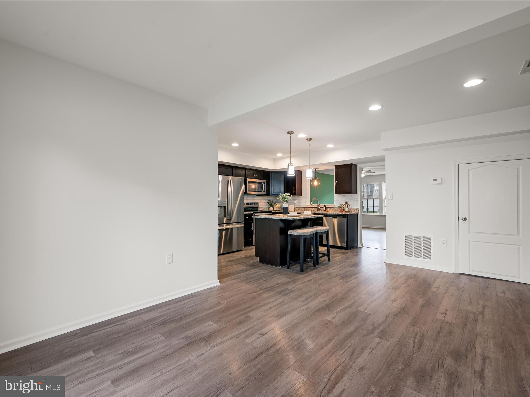 576 Thumper Drive Ranson, WV 25438 - Photo 18 of 37 a kitchen with a sink and chairs